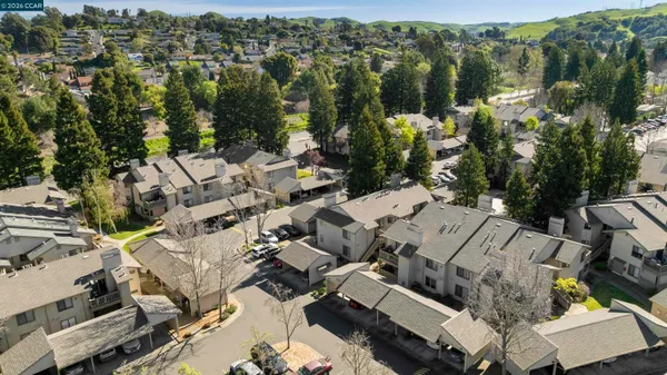 an aerial view of multiple houses with yard