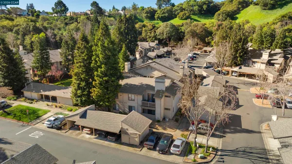 an aerial view of multiple houses with yard