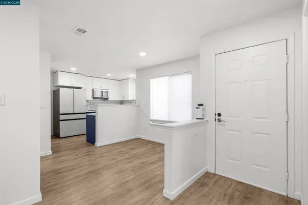 a view of a kitchen with wooden floor