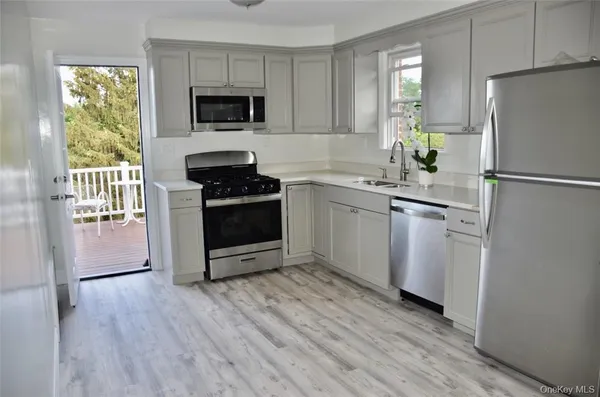 a kitchen with a stove a refrigerator and a sink