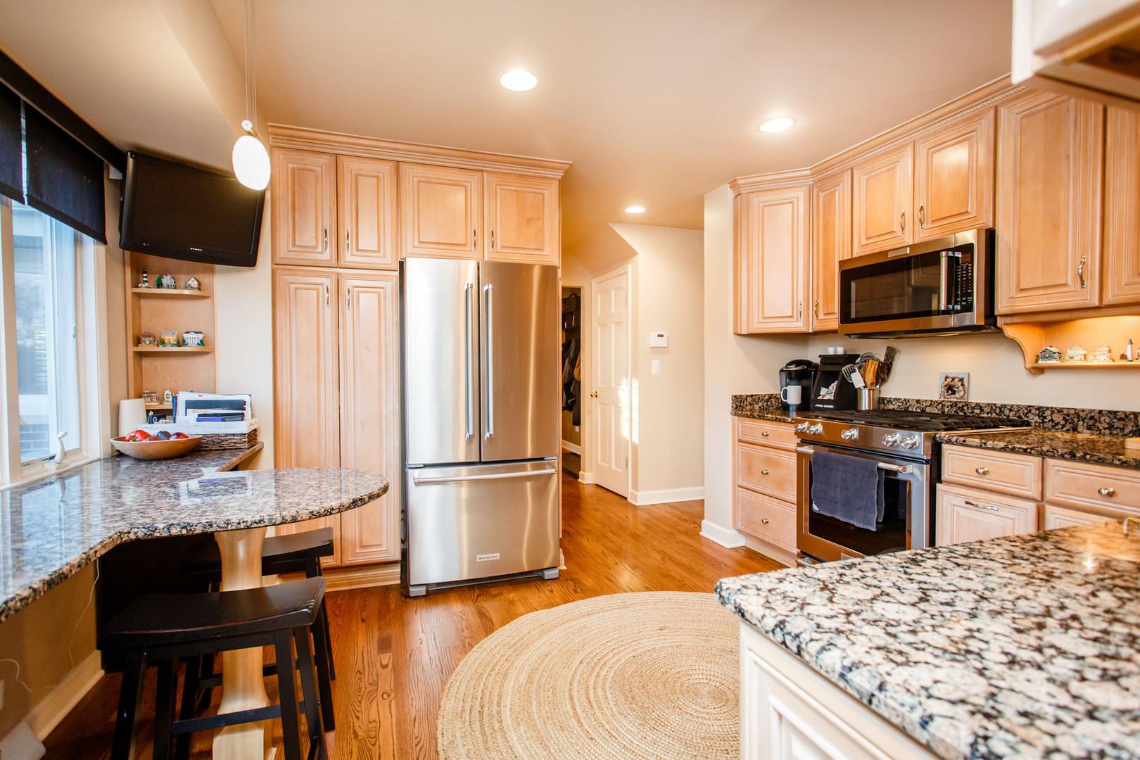 25 Mulberry Road Deerfield, IL 60015 - Photo 16 of 63 a kitchen with stainless steel appliances kitchen island granite countertop a refrigerator stove microwave and sink