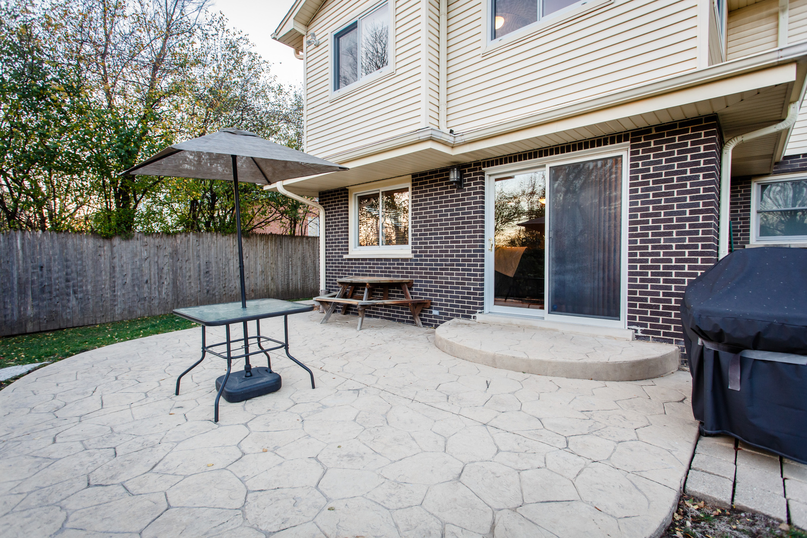 25 Mulberry Road Deerfield, IL 60015 - Photo 56 of 63 a view of a chairs and table in backyard of the house