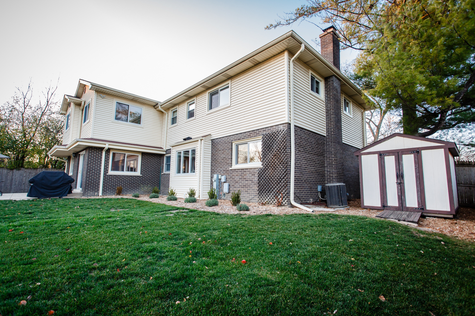 25 Mulberry Road Deerfield, IL 60015 - Photo 58 of 63 a front view of a house with garden and trees