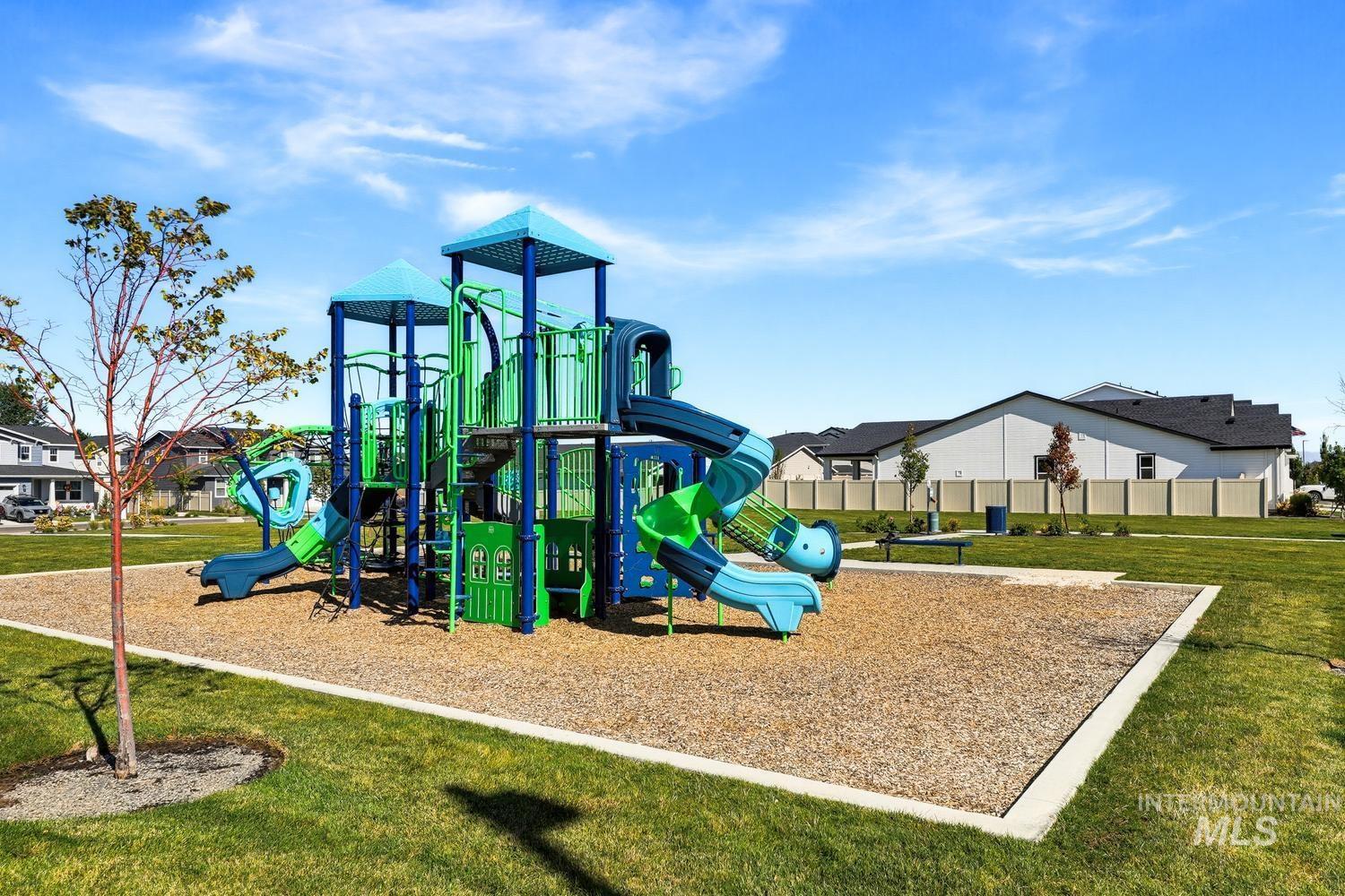 5990 West Ladle Rpds Street Meridian, ID 83646 - Photo 41 of 42 Community park featuring a play structure with slides and climbing elements, surrounded by a wood chip surface