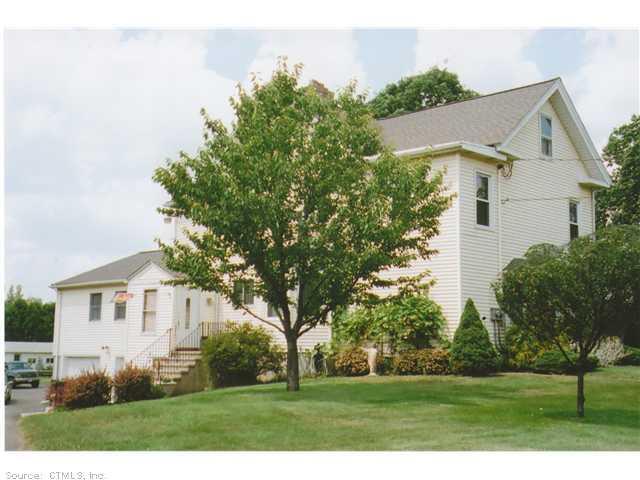 978 North Colony Road Meriden, CT 06450 - Photo 1 of 1 a view of a white house next to a yard with big trees
