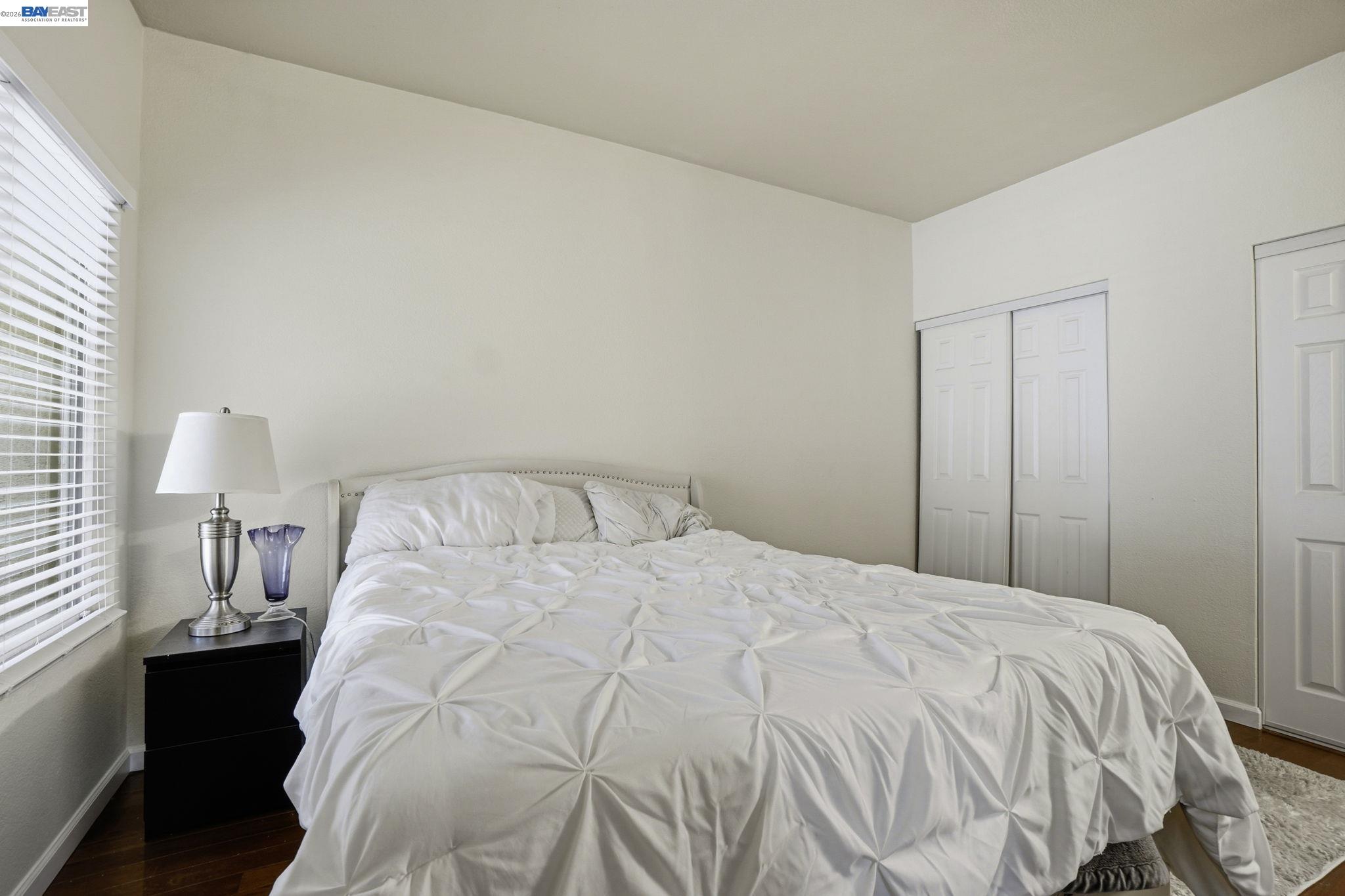 1405 Forest Run Hercules, CA 94547 - Photo 13 of 26 a large bed sitting in a bedroom next to a lamp
