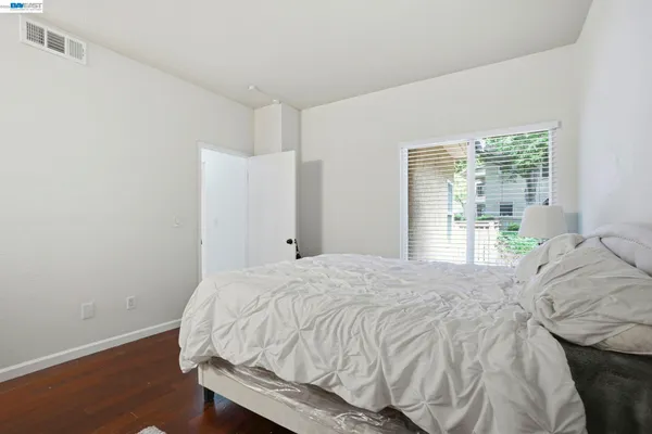 a bed sitting in a bedroom next to a window