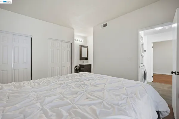 a bedroom with a bed and a mirror