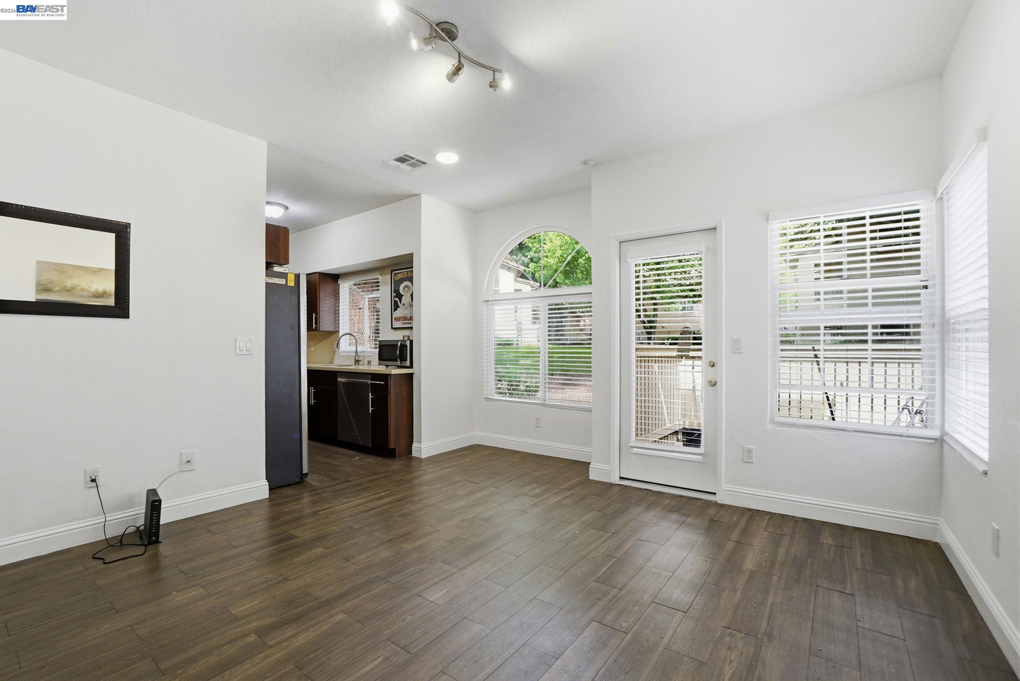 1405 Forest Run Hercules, CA 94547 - Photo 6 of 26 a view of an empty room with a window and wooden floor