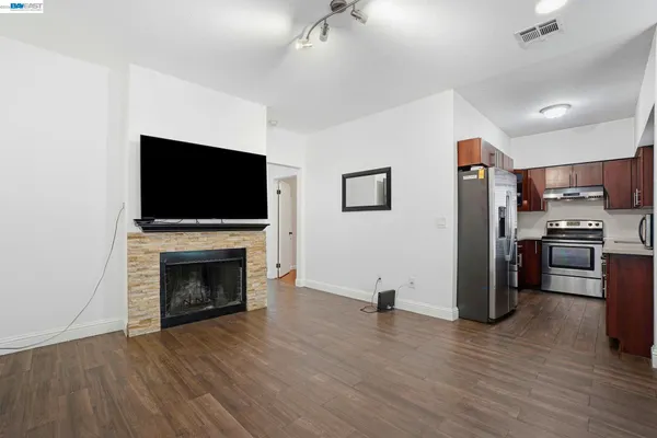 a view of kitchen with furniture microwave and refrigerator