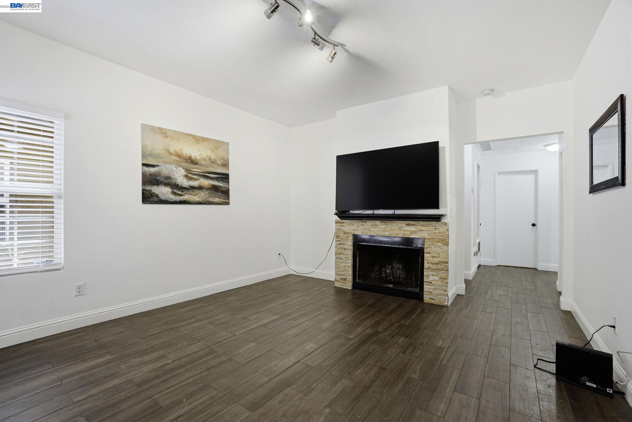 1405 Forest Run Hercules, CA 94547 - Photo 8 of 26 an empty room with furniture fireplace and wooden floor