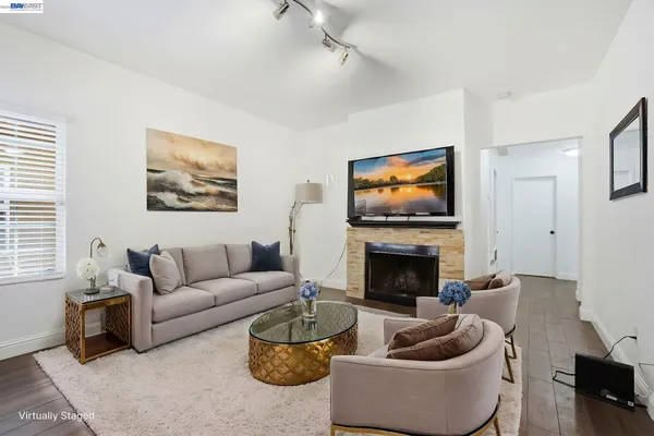 a living room with furniture a fireplace and a flat screen tv