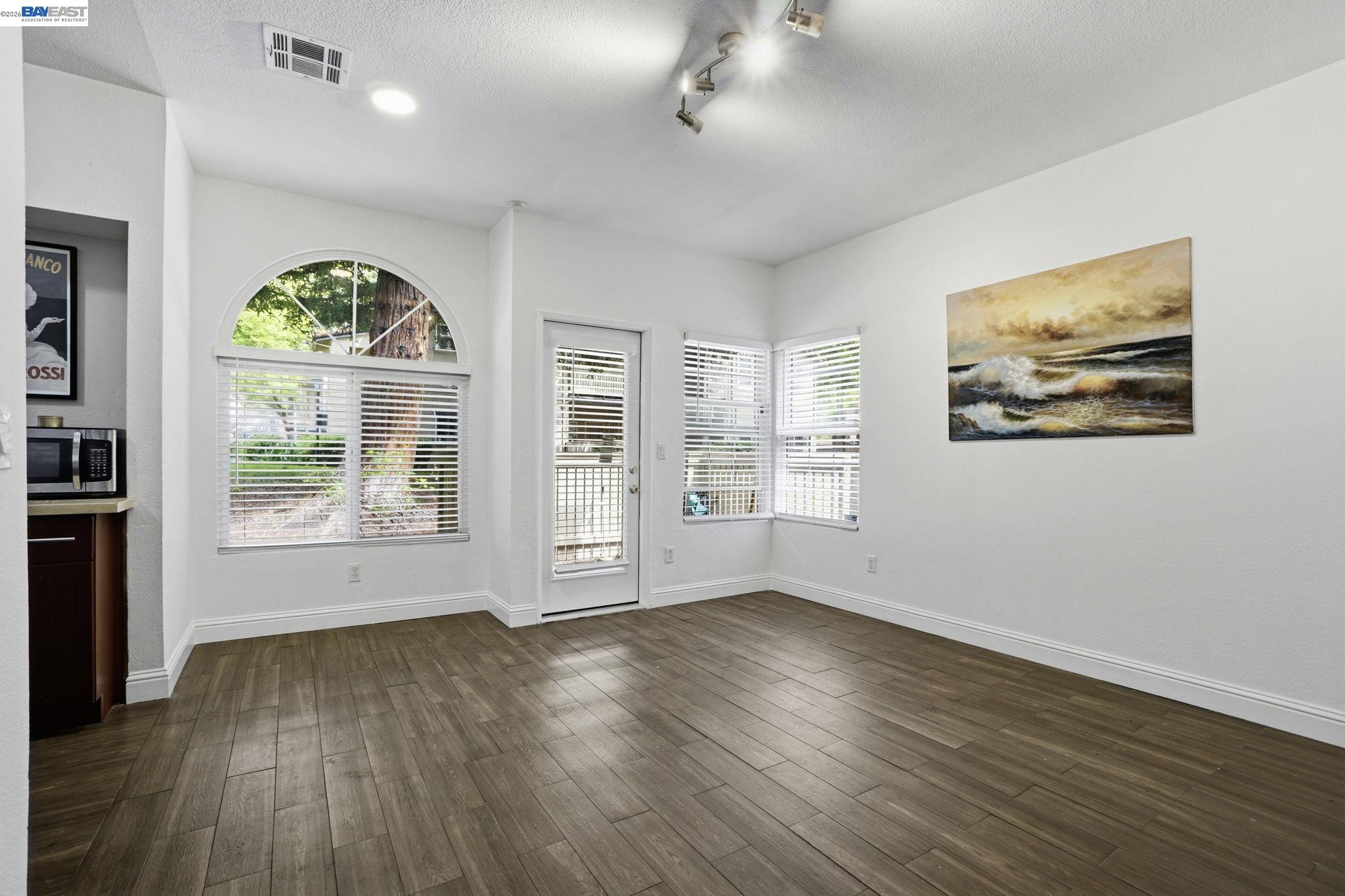 1405 Forest Run Hercules, CA 94547 - Photo 10 of 26 a view of an empty room with a window and wooden floor