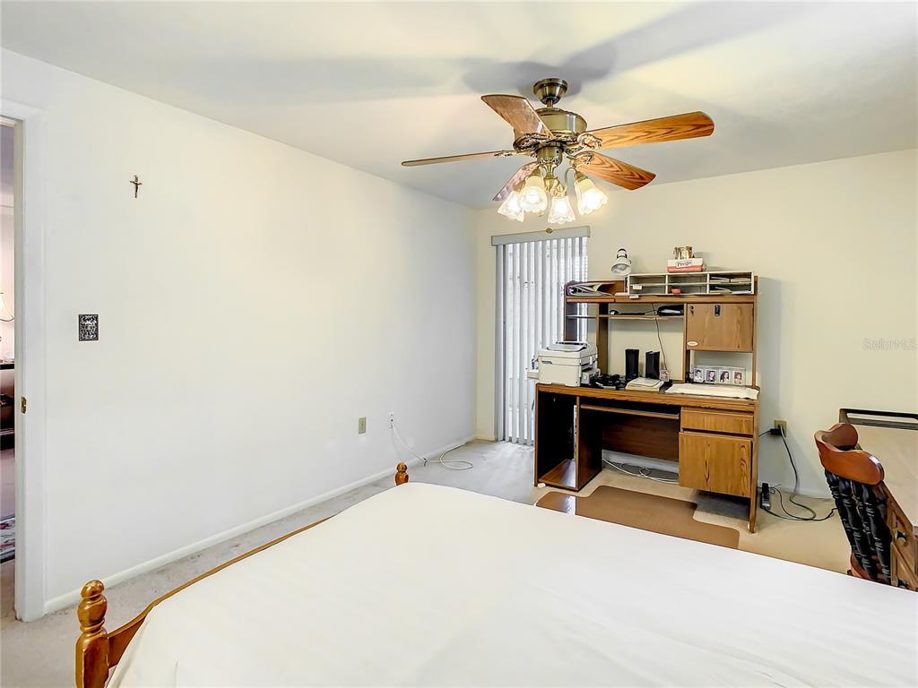 4230 Redcliff Place, Unit 4230 New Port Richey, FL 34652 - Photo 15 of 42 a bedroom with a bed and a chandelier
