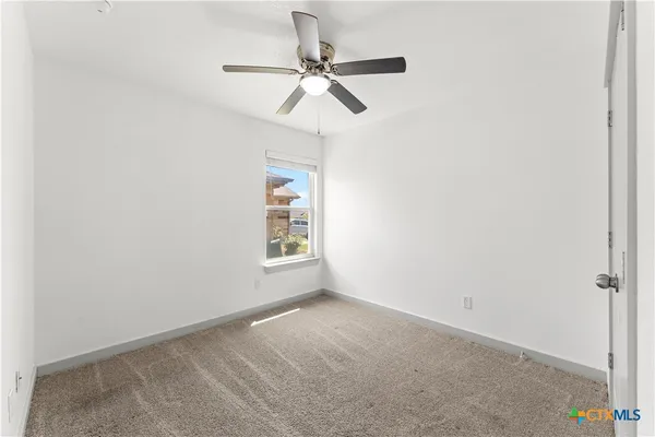 a view of a livingroom with a ceiling fan and window