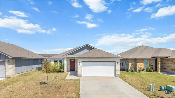 a view of a house with a yard and garage