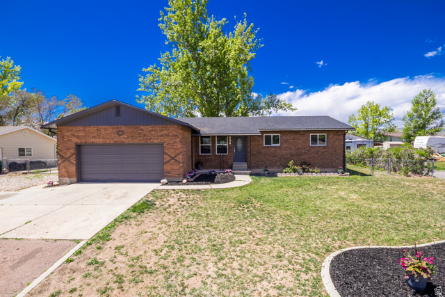 634 South 2100th Street West Vernal, UT 84078 - Photo 57 of 71 Brick exterior with a dark shingle roof and an integrated garage