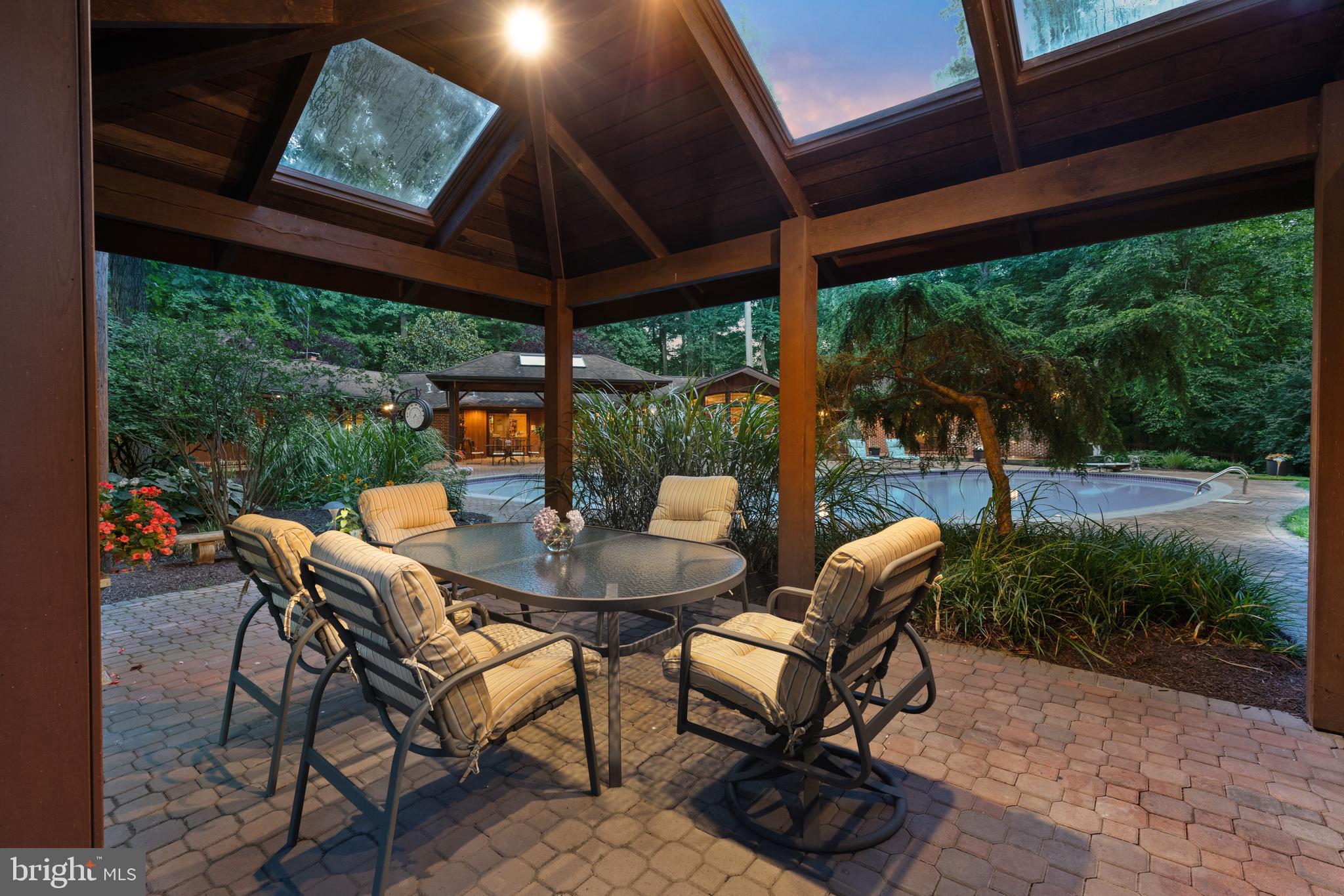 10810 Baronet Road Owings Mills, MD 21117 - Photo 14 of 83 a view of a patio with a table and chairs under an umbrella