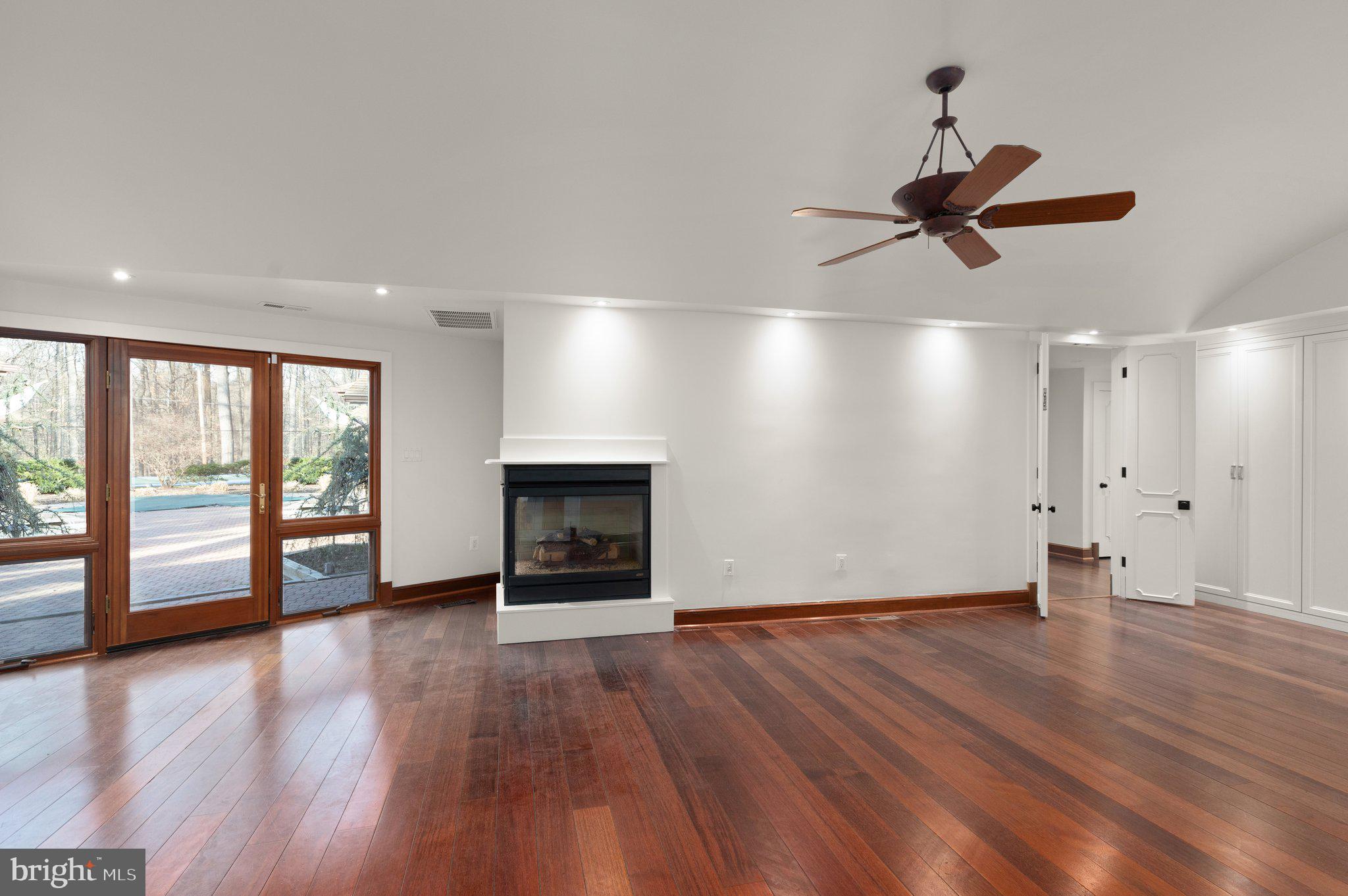 10810 Baronet Road Owings Mills, MD 21117 - Photo 66 of 83 an empty room with wooden floor and windows