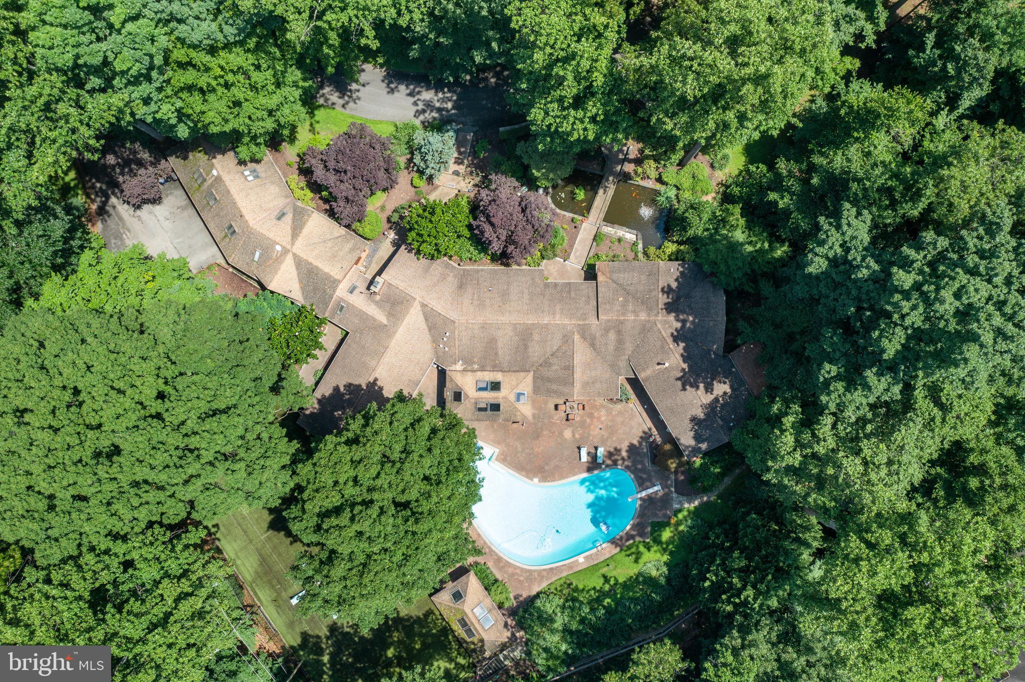 10810 Baronet Road Owings Mills, MD 21117 - Photo 8 of 83 an aerial view of a house with a yard and large trees