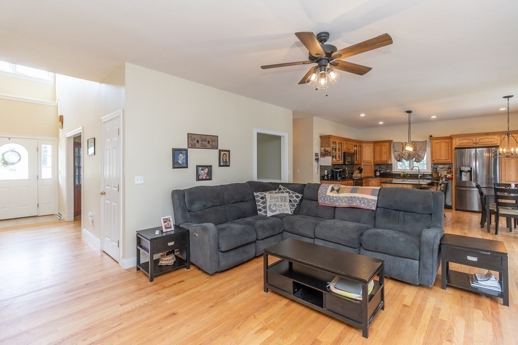 46 Radisson Lane Westfield, MA 01085 - Photo 15 of 40 a living room with furniture kitchen view and a wooden floor