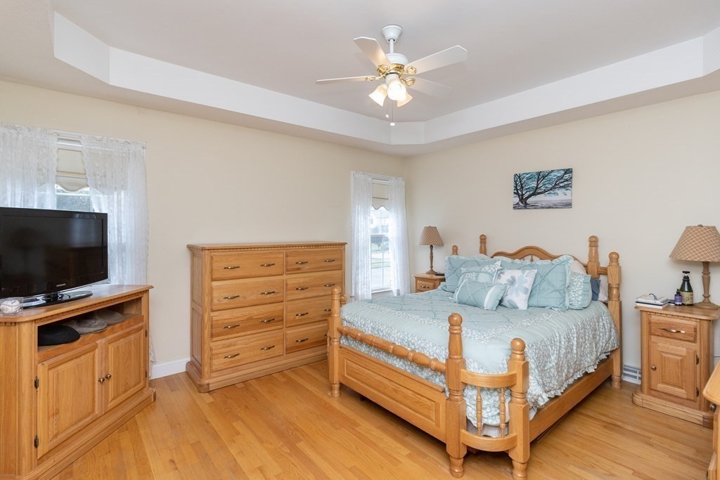 46 Radisson Lane Westfield, MA 01085 - Photo 18 of 40 a spacious bedroom with a bed and a flat screen tv