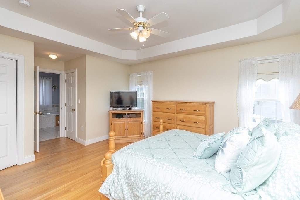 46 Radisson Lane Westfield, MA 01085 - Photo 20 of 40 a bedroom with a bed and a chandelier