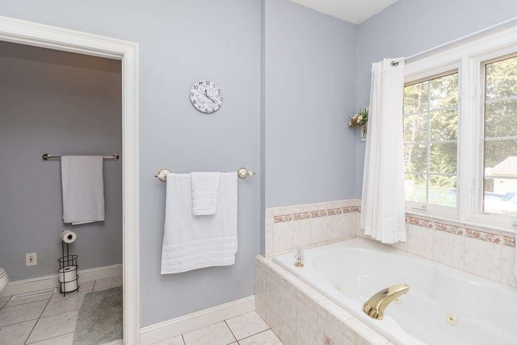46 Radisson Lane Westfield, MA 01085 - Photo 23 of 40 a bathroom with a tub a sink and a window