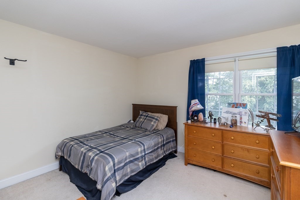 46 Radisson Lane Westfield, MA 01085 - Photo 29 of 40 a bedroom with a bed and large windows