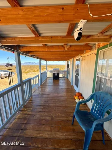 a view of a balcony with wooden floor