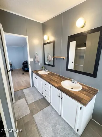 a bathroom with a double vanity sink and a mirror