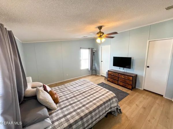 a bedroom with a bed and a flat screen tv