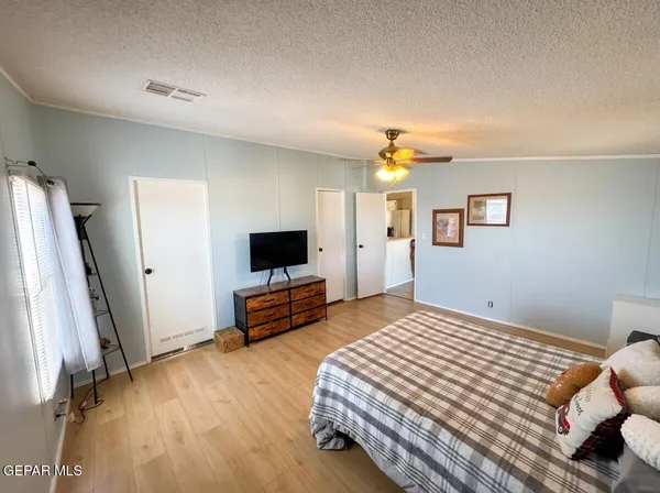 a bedroom with furniture and wooden floor