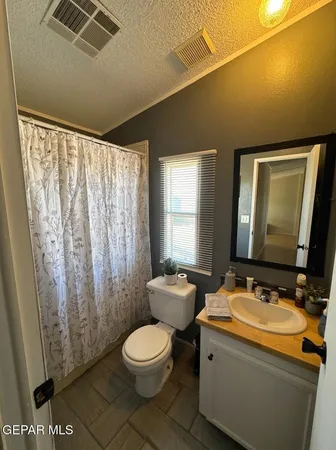 a bed room with a bed and a chair