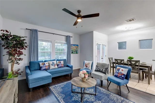 a living room with furniture and a large window with garden view