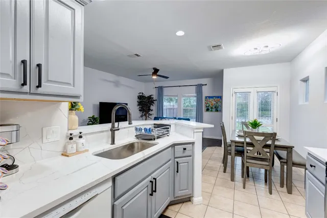a kitchen with a sink refrigerator and cabinets