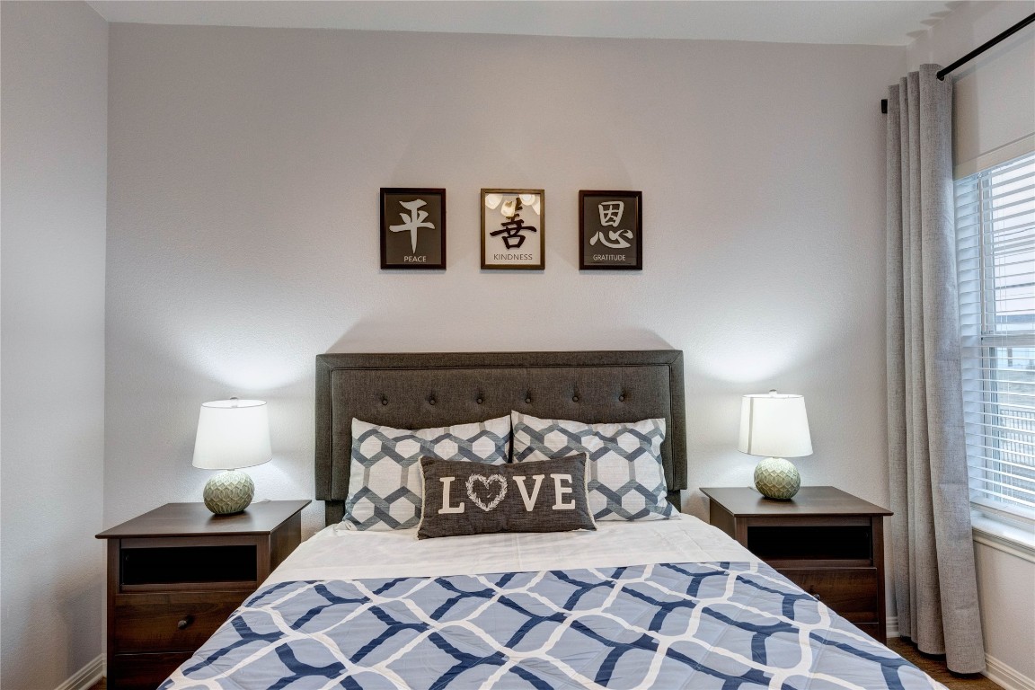 7510 Lazy Creek Drive, Unit B Austin, TX 78724 - Photo 22 of 36 a bedroom with a bed and a lamp on dresser