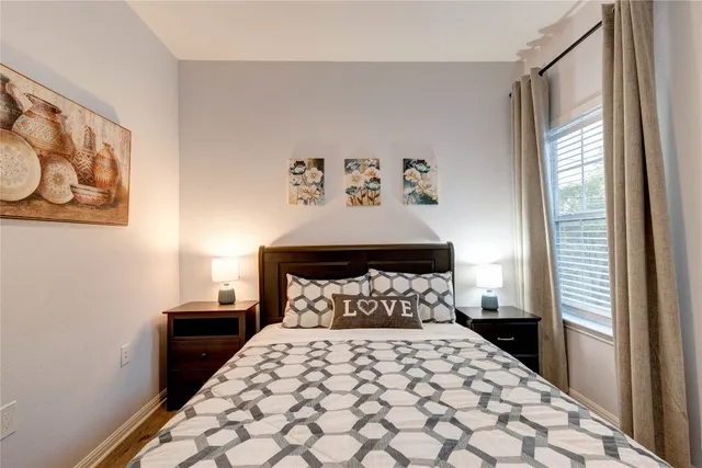 a bedroom with a large bed and a window