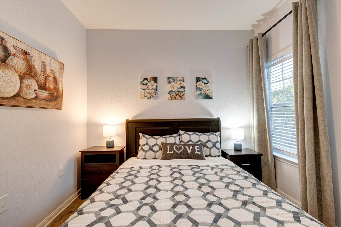 7510 Lazy Creek Drive, Unit B Austin, TX 78724 - Photo 24 of 36 a bedroom with a large bed and a window