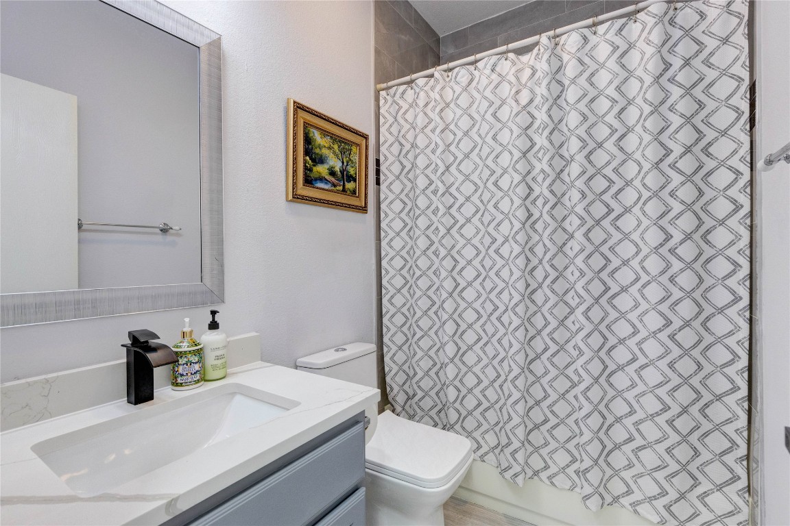 7510 Lazy Creek Drive, Unit B Austin, TX 78724 - Photo 25 of 36 a bathroom with a sink and a toilet