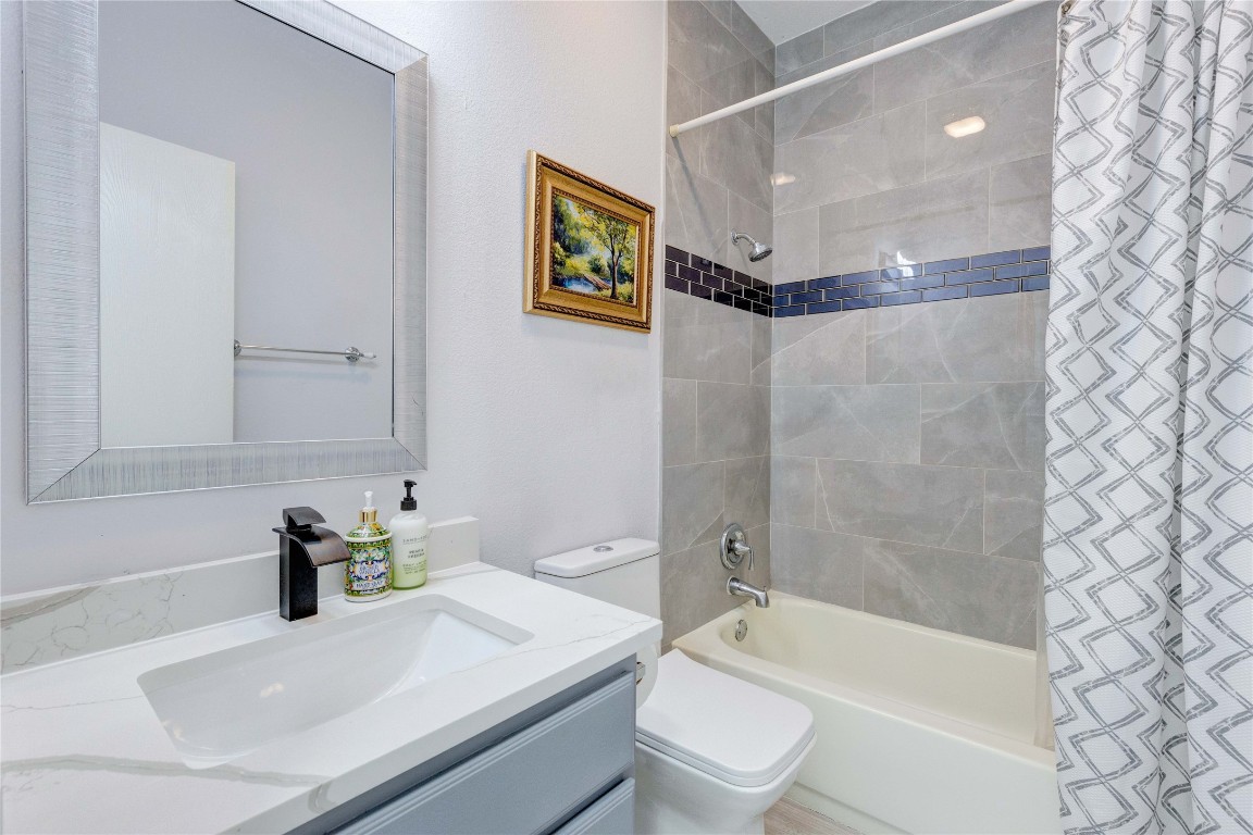 7510 Lazy Creek Drive, Unit B Austin, TX 78724 - Photo 26 of 36 a bathroom with a sink a toilet and shower