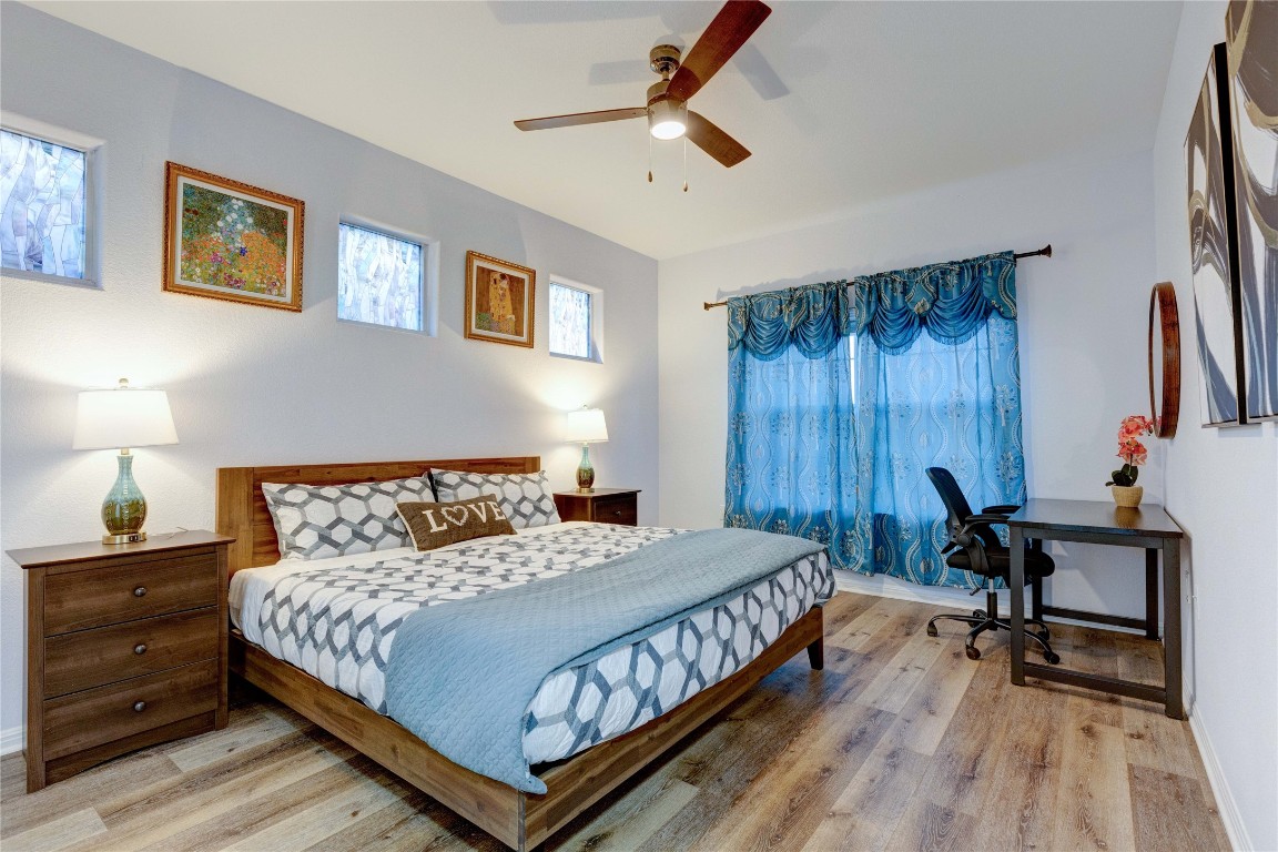 7510 Lazy Creek Drive, Unit B Austin, TX 78724 - Photo 27 of 36 a bedroom with a bed a desk and chair