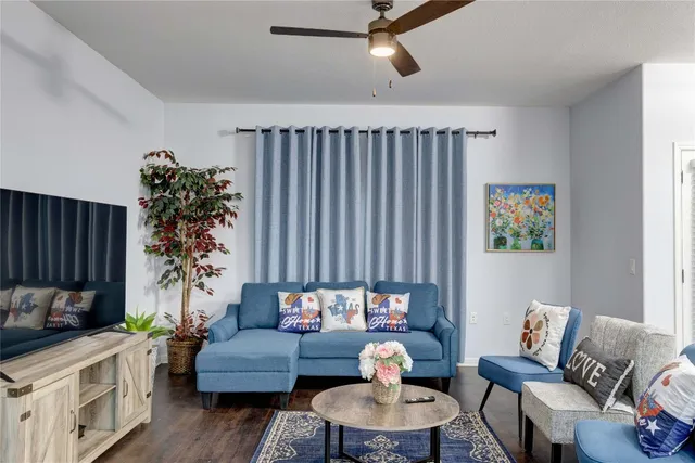 a living room with furniture and a potted plant