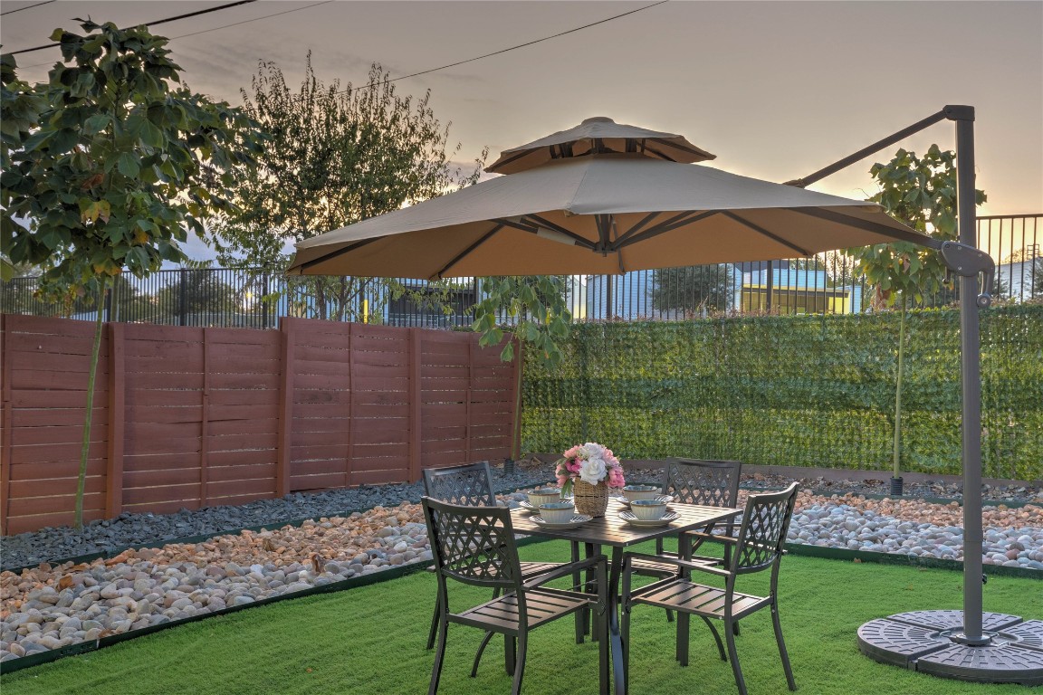 7510 Lazy Creek Drive, Unit B Austin, TX 78724 - Photo 33 of 36 a view of a chair and table in backyard
