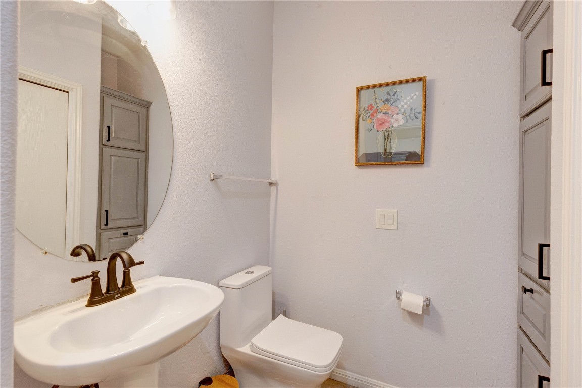 7510 Lazy Creek Drive, Unit B Austin, TX 78724 - Photo 10 of 36 a bathroom with a toilet sink and mirror