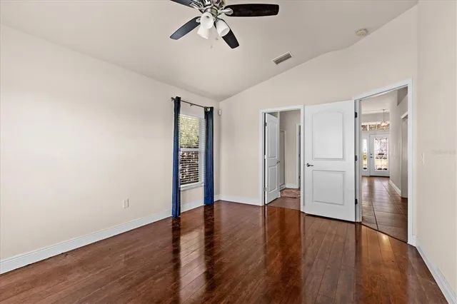 a view of empty room with wooden floor