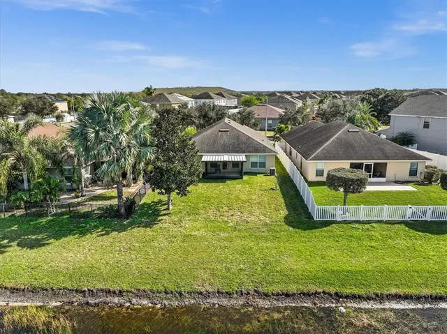 an aerial view of a house with a swimming pool patio and outdoor seating