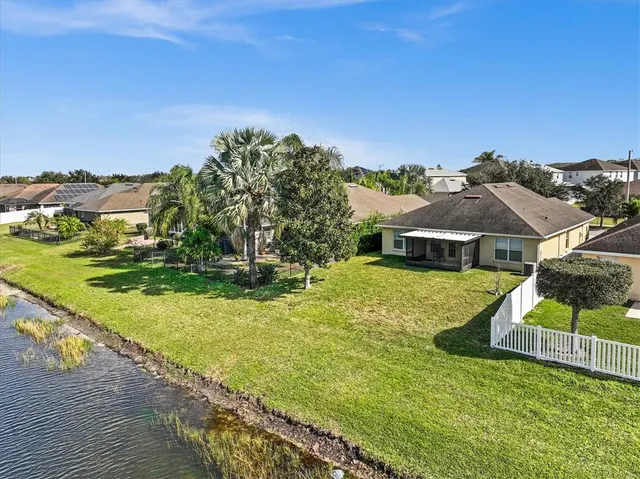 an aerial view of a residential houses with outdoor space