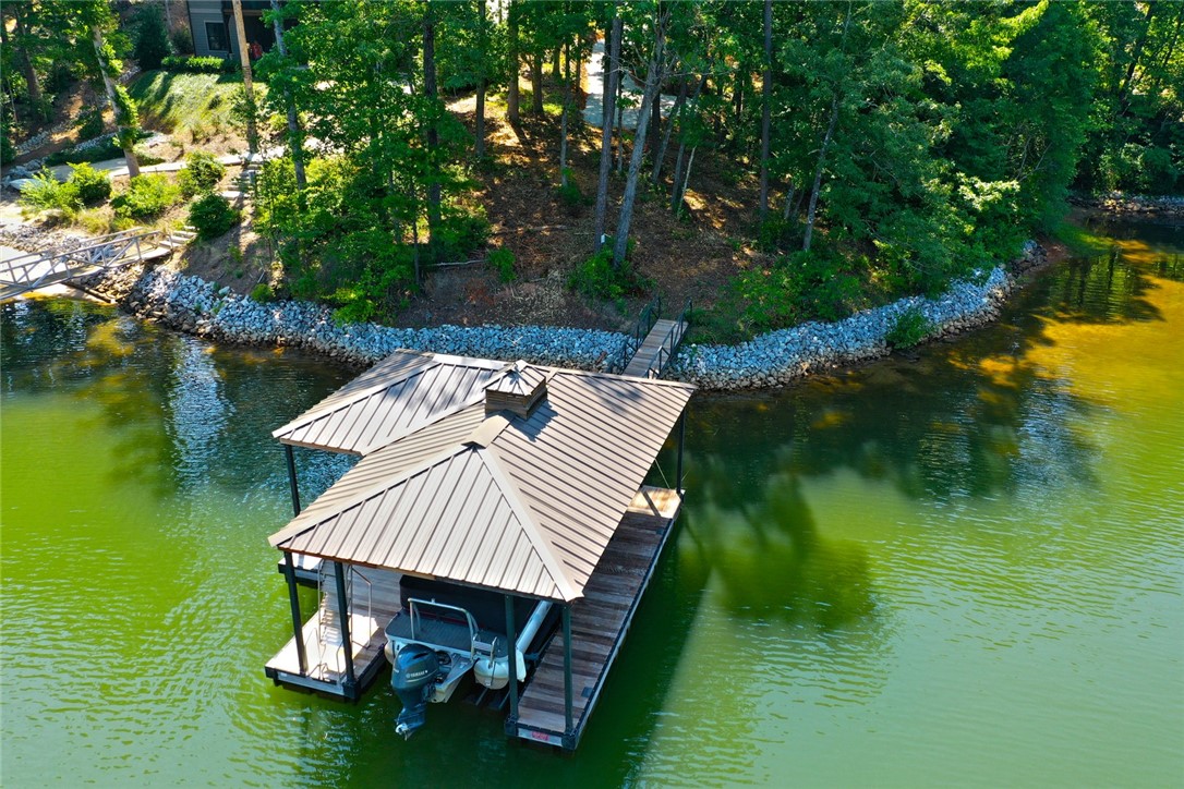 1359 Hbr Rdg Road Seneca, SC 29672 - Photo 8 of 39 A private boat dock and slip offer immediate access to the serene lake, perfect for aquatic recreation.