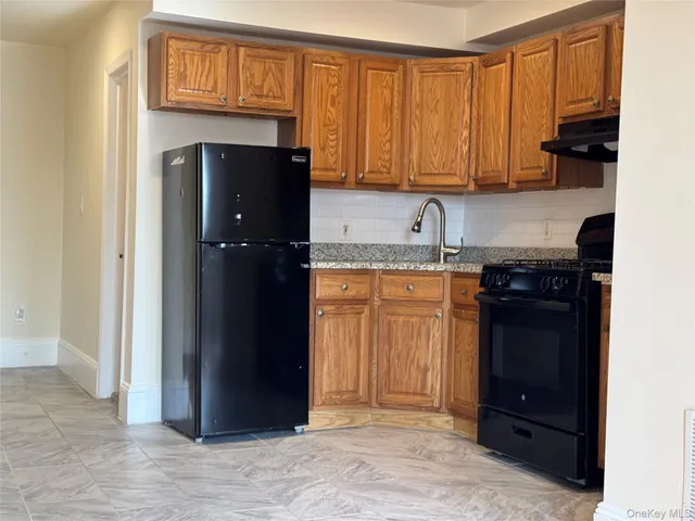 a kitchen with a refrigerator and cabinets